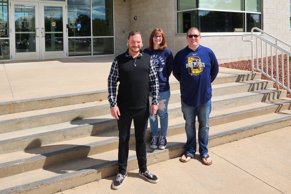 2022-23 Fond du Lac Executive Team - Three Students in front of Fond du Lac Campus main entry