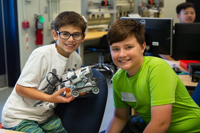 Two boys in TKC with the robot they built