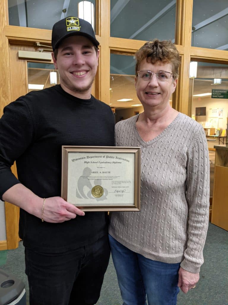Ariel Baute of Fond du Lac showing his diploma while standing next to Deb Schuh, Fond du Lac Instructor.
