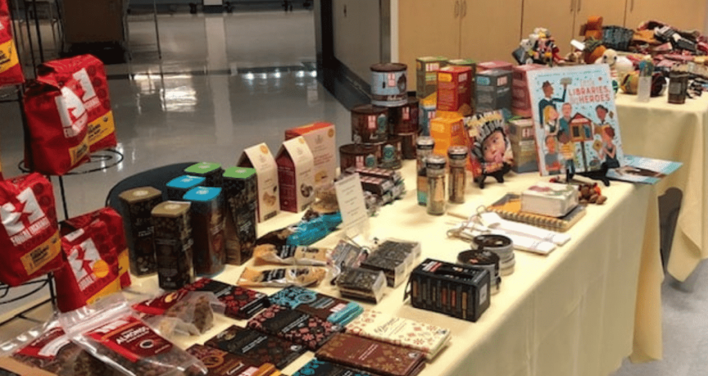 Assortment of fair trade products like coffee and chocolate on a table.