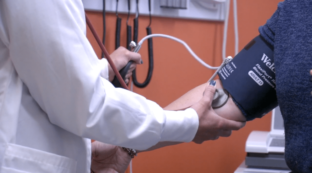 Medical Assistant taking blood pressure.