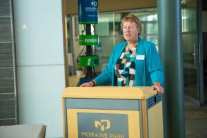 Moraine Park President Bonnie Baerwald speaking at the podium.