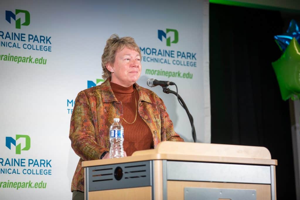 Moraine Park President, Bonnie Baerwald, talking at a podium