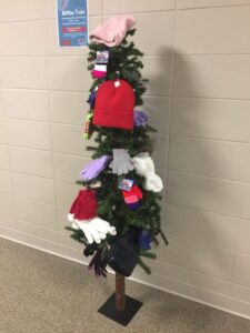 Christmas tree decorated with warm mittens and gloves.