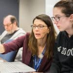 Accounting student talking to instructor.