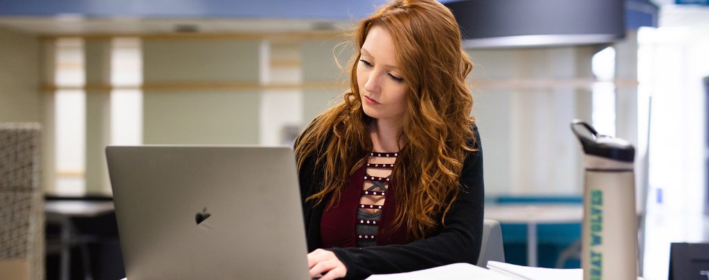 female student sitting with laptop