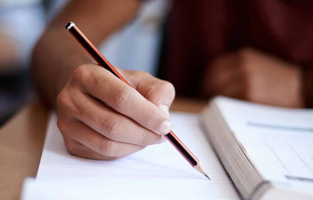 Hand holding pencil.