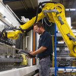 man using manufacturing equipment and tools