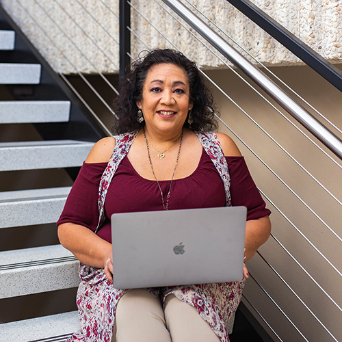 female student holding laptop