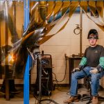 Moraine Park welding student proudly presenting his work station.