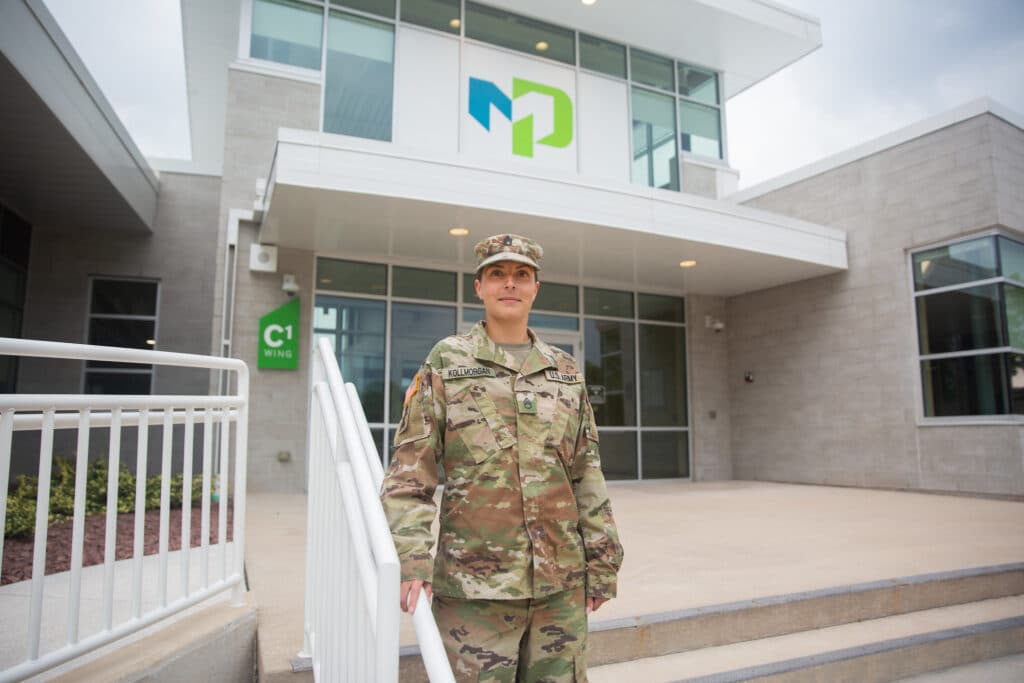 Veteran student standing in front of Moraine Park front entrance.