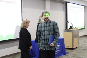 Student receiving his welding boot camp certificate
