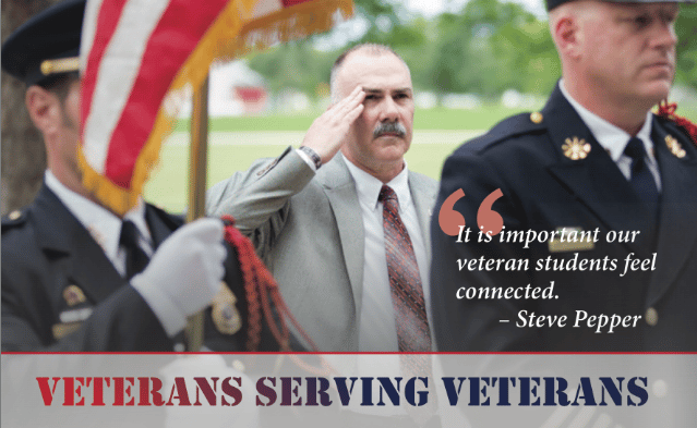 Steve Pepper saluting next to soldiers.