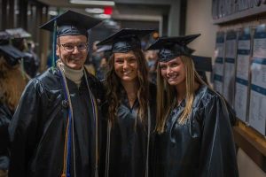 Three students at 2022 winter commencement