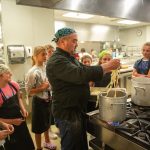 Culinary instructor showing students how to cook