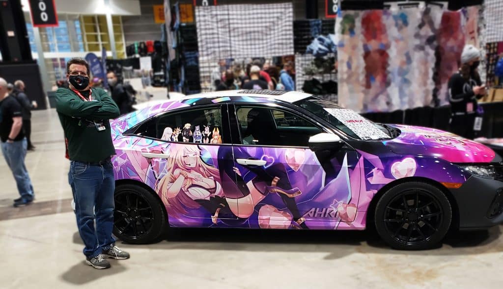 Moraine Park Student next to a car