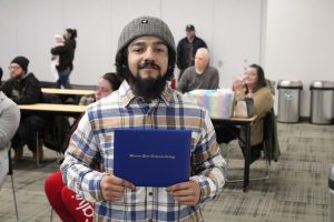 Boot camp graduate showing diploma
