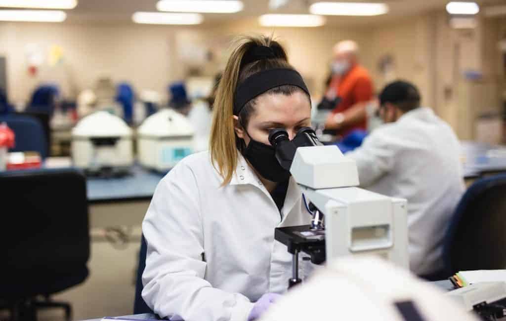 Moraine Park student looking into a microscope. 