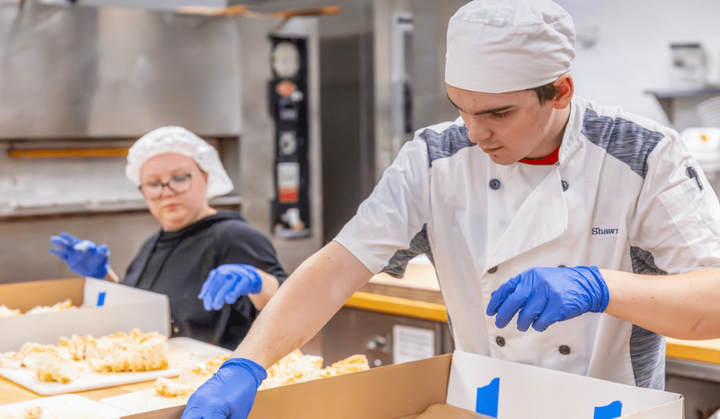 Students cutting angel food cake