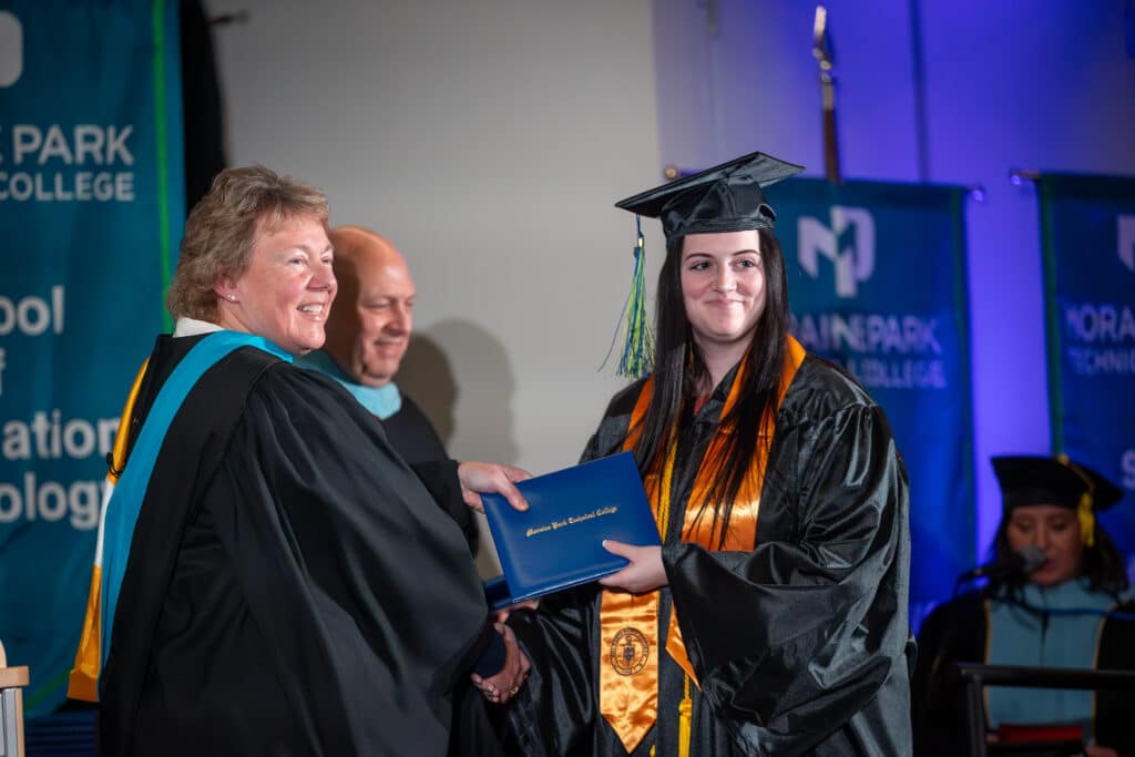 Student receiving their degree during the commencement ceremony.