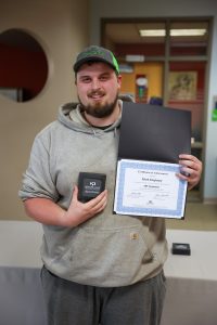 Mark Singletary, Apprenticeship grad holding his diploma and award.