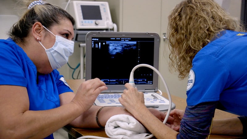 Sonography instructors using equipment