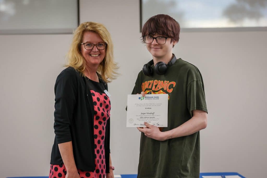 A student receiving the physical Career Academy certification from a Moraine Park staff.