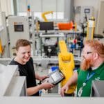 A student getting taught about CNC machines by a Moraine Park instructor.