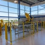 Inside view of Moraine Park's new Advanced Manufacturing Center on the West Bend Campus. Machines contrast with the outside landscape.