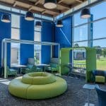 Blue and green-themed inside student lounge area of Moraine Park's new Advanced Manufacturing Center on the West Bend Campus.