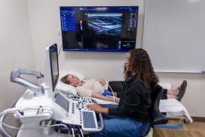 Diagnostic Medical Sonography student performing an ultrasound.