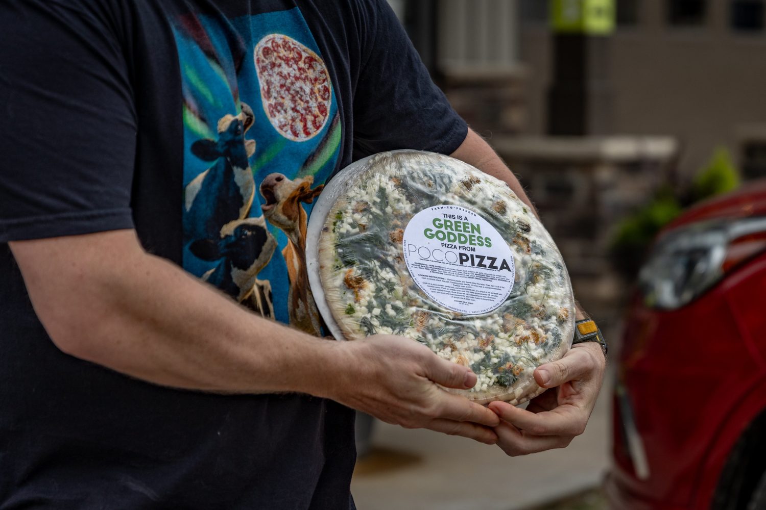 Shawn holding one of his pizzas