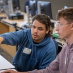 Students studying at a desktop PC.