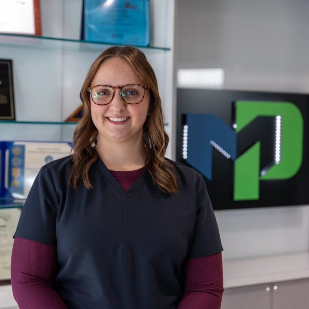 Brittany Wenzlaff smiling in her scrubs.