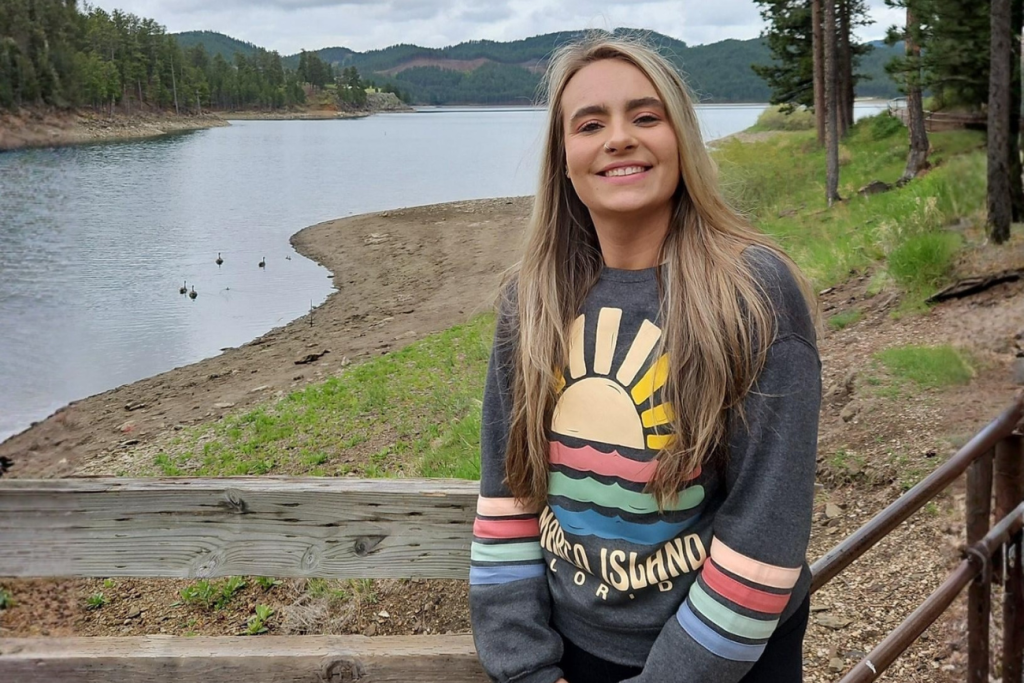 Alison Wolf, human resources student, smiling in nature