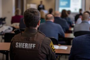 photo of classroom with sheriff seated.