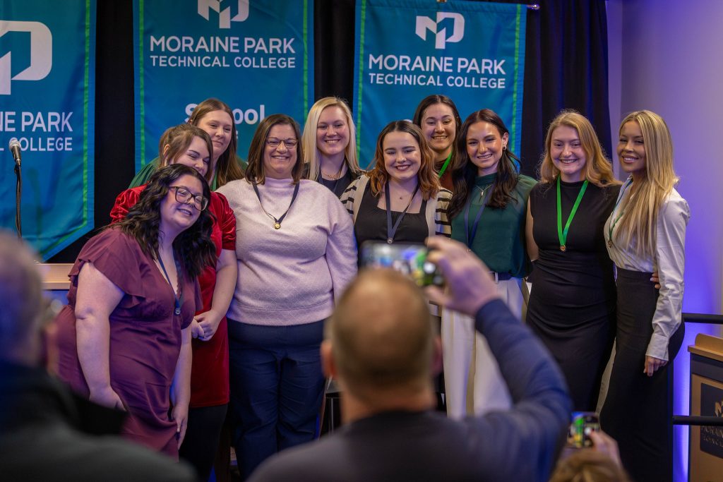 Nurses smiling for a picture at their pinning ceremony