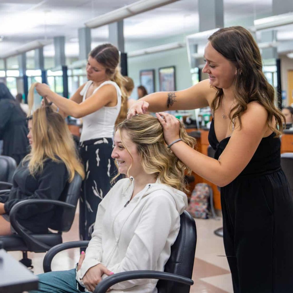 Cosmetology classroom with students working