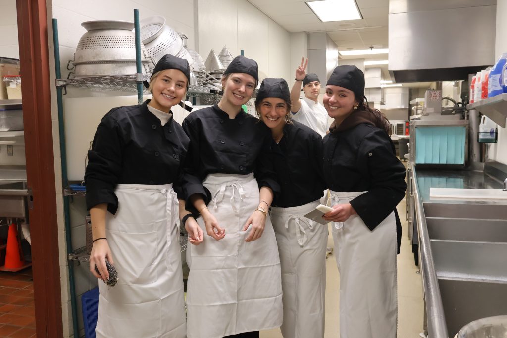 St. Mary's Springs students in culinary classroom smiling in a group.