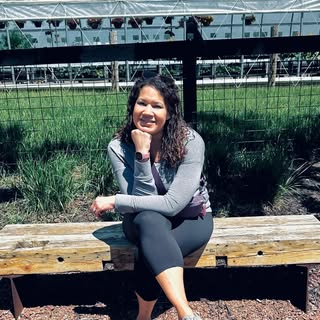Laurice Snyder of Rooted Wings sitting on a bench.