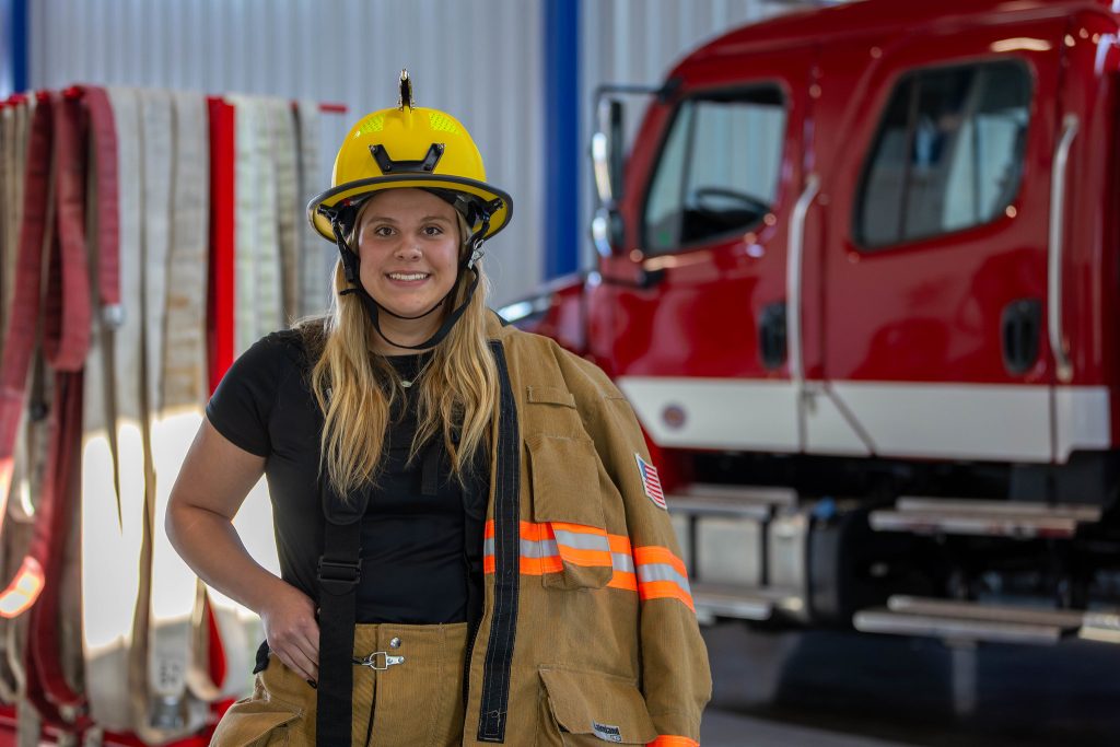 Fire Student Macy Nikkinen posing in her fire gear.
