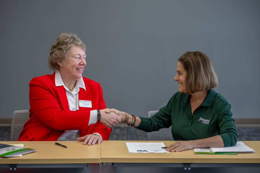 President Bonnie Baerwald happily shaking hands with Yavapai College President Dr. Lisa Rhine