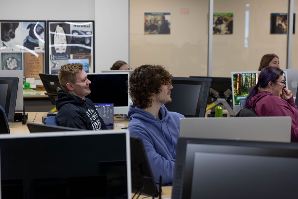 Arik Lange sitting in computer lab.