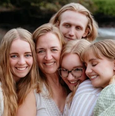 Debbie Pollesch, surrounded by her four children.