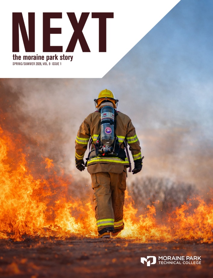 Cover of the Spring/Summer 2026 issue of Moraine Park's NEXT Magazine with a firefighter walking through fire on it.