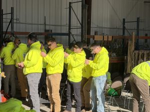 EPD students pinning numbers for the competition on each others backs.