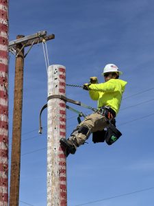 EPD Student suspended on a pole during the electrical competition.
