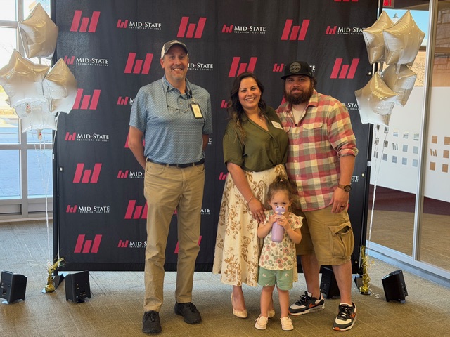 Val and her family pose at the Pitch Competition.