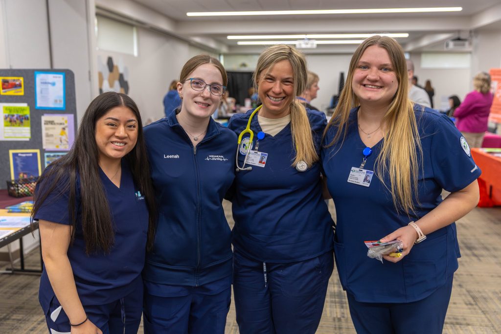 Four MPTC health care students pose smiling at the camera.