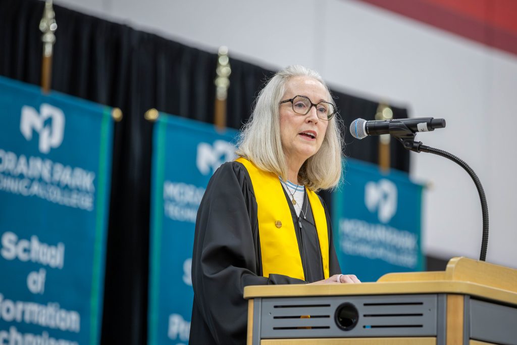 Shelly A. Waala speaking at the podium.